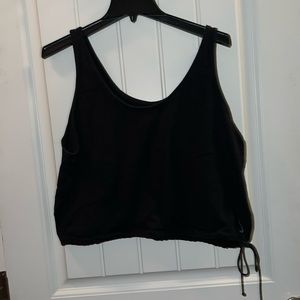 Nike cropped work out shirt with tie on bottom. No stains or holes.